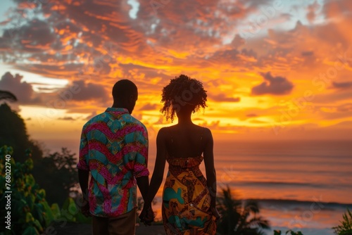 Romantic African Couple Holding Hands Watching Sunset on Beach, Perfect Moment in Time with Colorful Sky and Gentle Waves photo