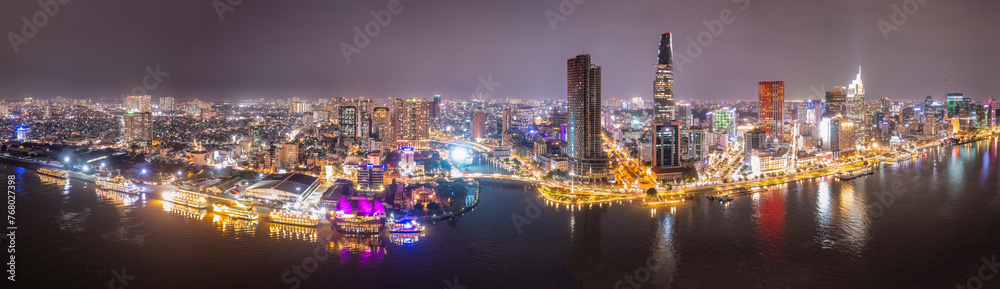 Aerial panoramic cityscape view of HoChiMinh city and the River Saigon, Vietnam with blue sky at sunset. View from Thu Thiem peninsula