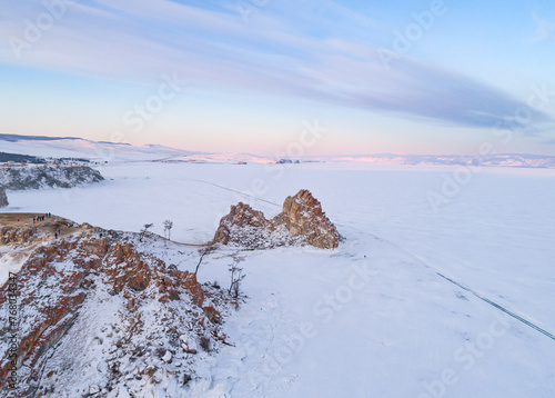 Aerial shot of a Shamanka rock on Olkhon island at sunset. Winter landscape. Popular touristic destination. Natural landmark. Panoramic view © Евгений Бахчев