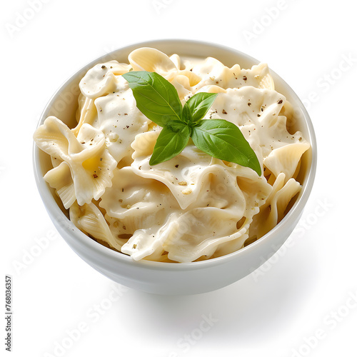 White bowl of creamy pasta top view isolated on white background
