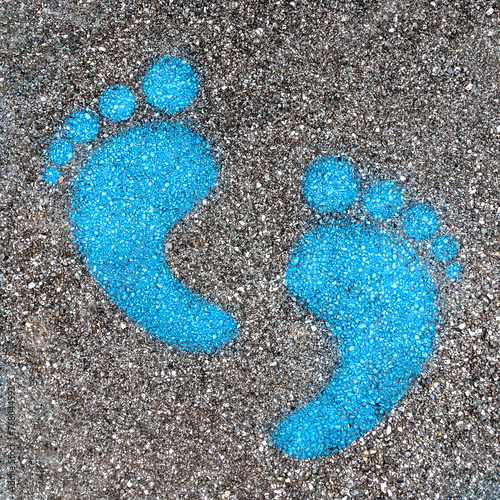 Blue footprint signs on an asphalt