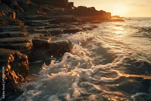 a rocky beach shore, with waves crashing against the rocks and the sun reflecting off the wet surfaces, creating a beautiful and serene atmosphere