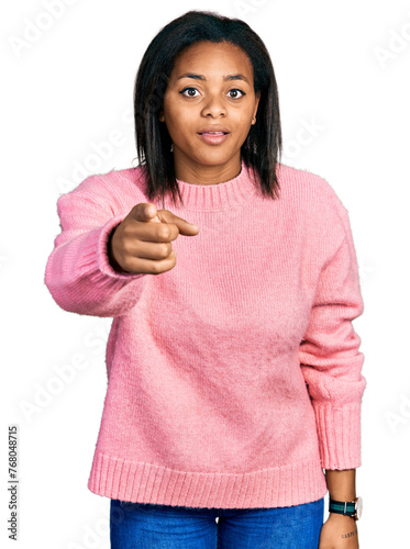 Beautiful hispanic woman wearing casual winter sweater pointing displeased and frustrated to the camera, angry and furious with you