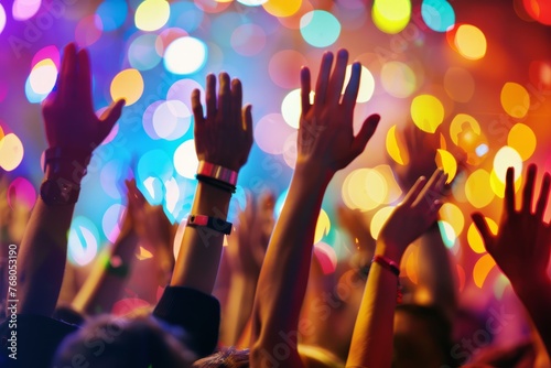 A group of people energetically raising their hands in the air during an event or celebration