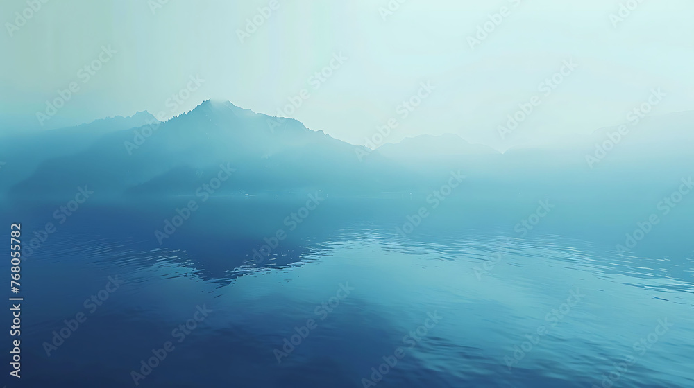 This is a beautiful landscape image of a lake and mountains in the distance. The water is a deep blue color and the sky is foggy.