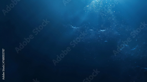 Deep blue ocean water with bright sun rays shining through the surface, creating a beautiful and serene underwater scene. photo