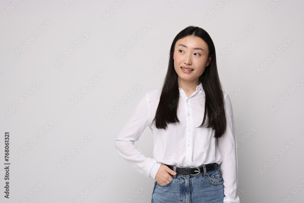 Portrait of smiling woman on light background. Space for text Portrait of smiling woman on light background. Space for text