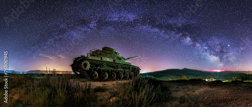 night view of a battle tank placed as a monument in the town of Quintanilla Cabe Rojas, in the Bureba region, Burgos, under a starry sky