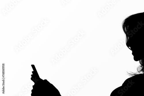 Dark human silhouette holds smartphone