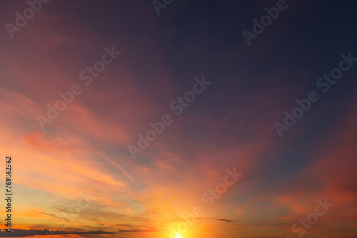 Epic Dramatic sunrise, sunset sky with cirrus clouds and yellow orsnge sun and sunlight abstract background texture