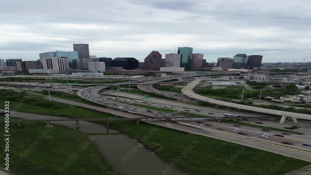 Traffic is bustling on a freeway with the downtown Houston, Texas skyline in the background. Traffic is bustling on a freeway with the downtown Houston, Texas skyline in the background.
