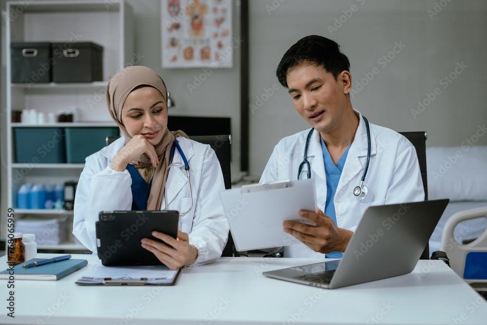 Pharmacists or doctors study information about tablets in the room in the evening. Pharmacists or doctors study information about tablets in the room in the evening.
