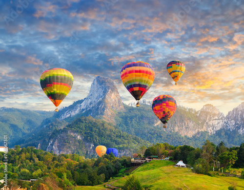 Colorful hot air balloons soar over the mountain