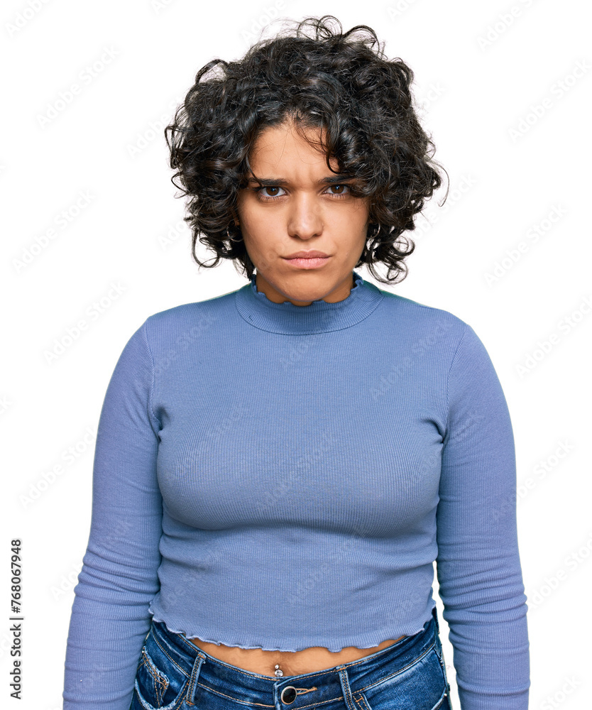 Young hispanic woman with curly hair wearing casual clothes skeptic and nervous, frowning upset because of problem. negative person. Young hispanic woman with curly hair wearing casual clothes skeptic and nervous, frowning upset because of problem. negative person.