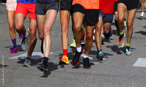 legs of many runners with sports sneakers during the foot race