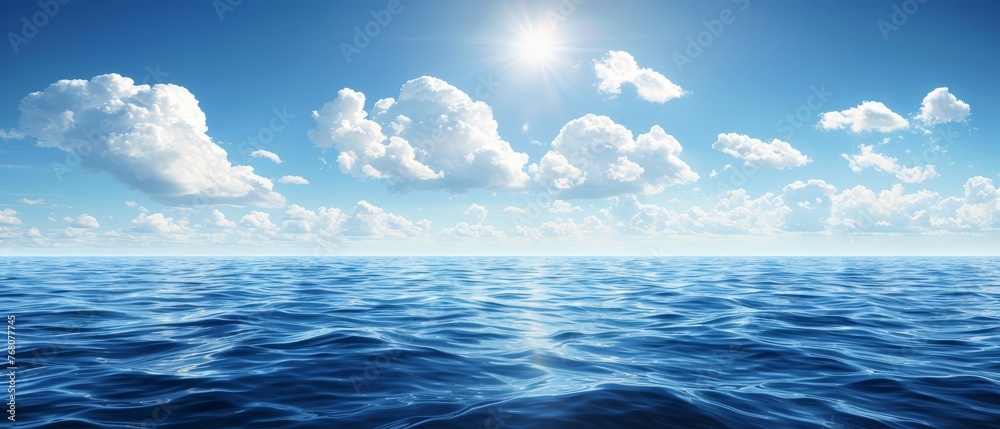   A large expanse of water beneath a blue sky, with the sun shining brightly from above