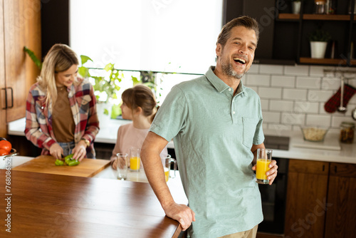 Smiling man holds a glass o...