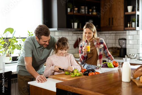 Family prepares a meal toge...
