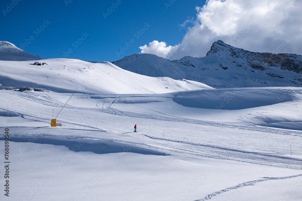 Landscaope snowy mountains and slope with skier 