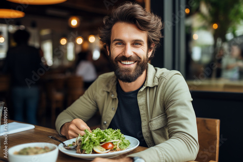 Generated with AI picture of handsome cheerful man in cafe eating tasty vegetables salad