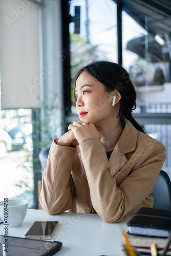Woman listening to music while working.