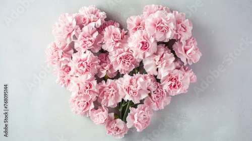 Bouquet of pink carnations arranged in a heart shape, symbolizing a mother's undying love and gratitude on Mother's Day.