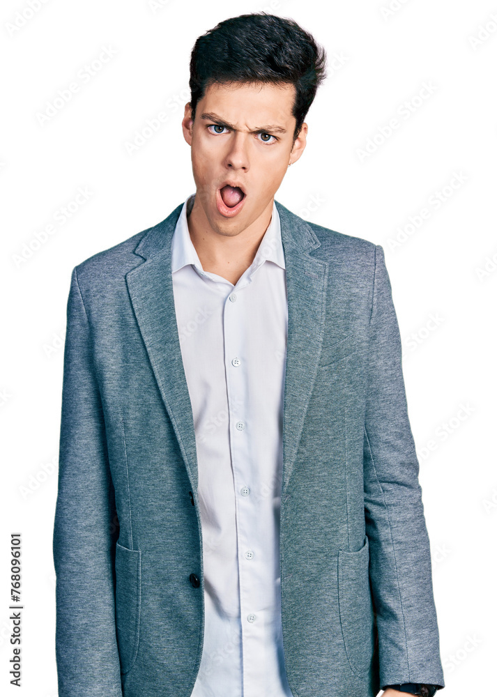 Young hispanic man wearing business clothes in shock face, looking skeptical and sarcastic, surprised with open mouth Young hispanic man wearing business clothes in shock face, looking skeptical and sarcastic, surprised with open mouth
