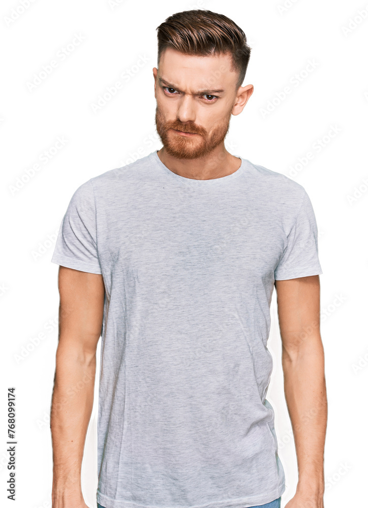 Young redhead man wearing casual grey t shirt skeptic and nervous, frowning upset because of problem. negative person. Young redhead man wearing casual grey t shirt skeptic and nervous, frowning upset because of problem. negative person.