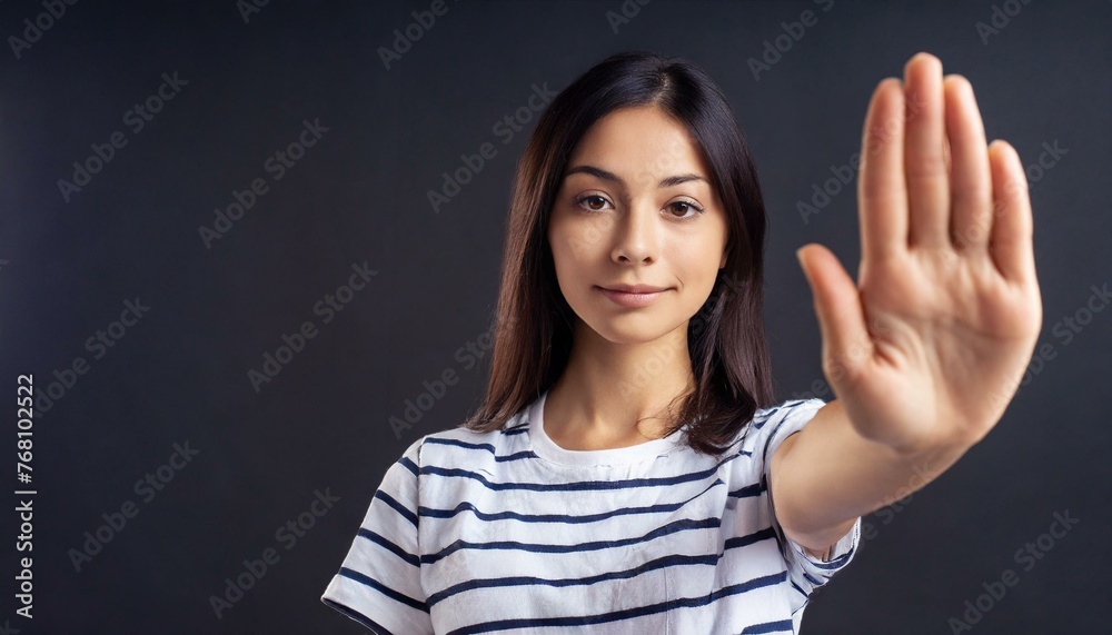 Close up of woman showing stop gesture with hand raising up on black background, young female protesting against domestic violence and abuse, bullying, saying no to gender discrimination Close up of woman showing stop gesture with hand raising up on black background, young female protesting against domestic violence and abuse, bullying, saying no to gender discrimination