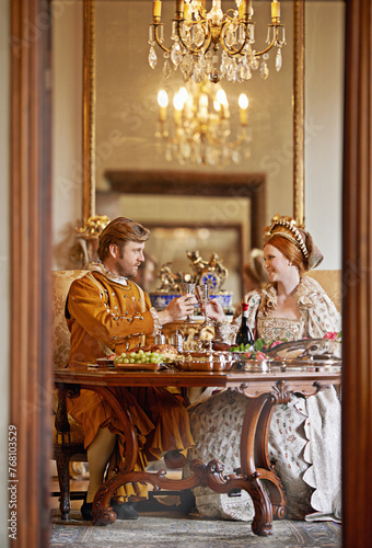 Royal, man and woman with wine for luxury and toast together for wedding and coronation. King and queen with smile for food with alcohol to drink in palace, happiness and joy for wealth in marriage