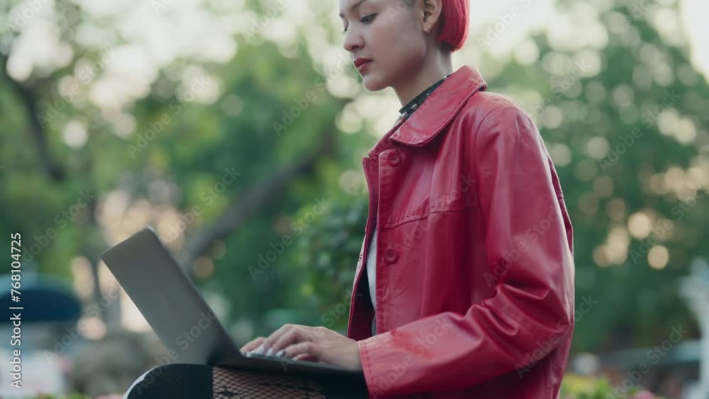 woman digital nomad using laptop working on the go