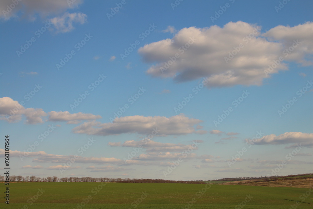 A field with blue sky and clouds A field with blue sky and clouds