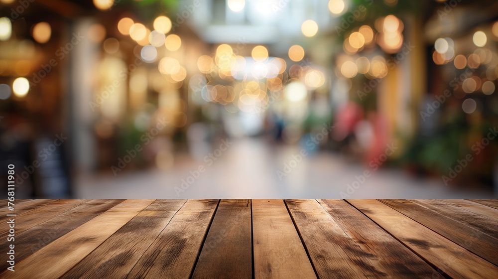 Rustic wooden table surface with a blurred warm-lit restaurant setting in the background