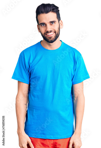 Wallpaper Mural Young handsome man with beard wearing casual t-shirt looking positive and happy standing and smiling with a confident smile showing teeth Torontodigital.ca