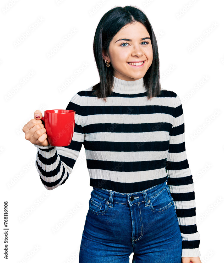 Young brunette woman with blue eyes drinking a cup of coffee looking positive and happy standing and smiling with a confident smile showing teeth Young brunette woman with blue eyes drinking a cup of coffee looking positive and happy standing and smiling with a confident smile showing teeth