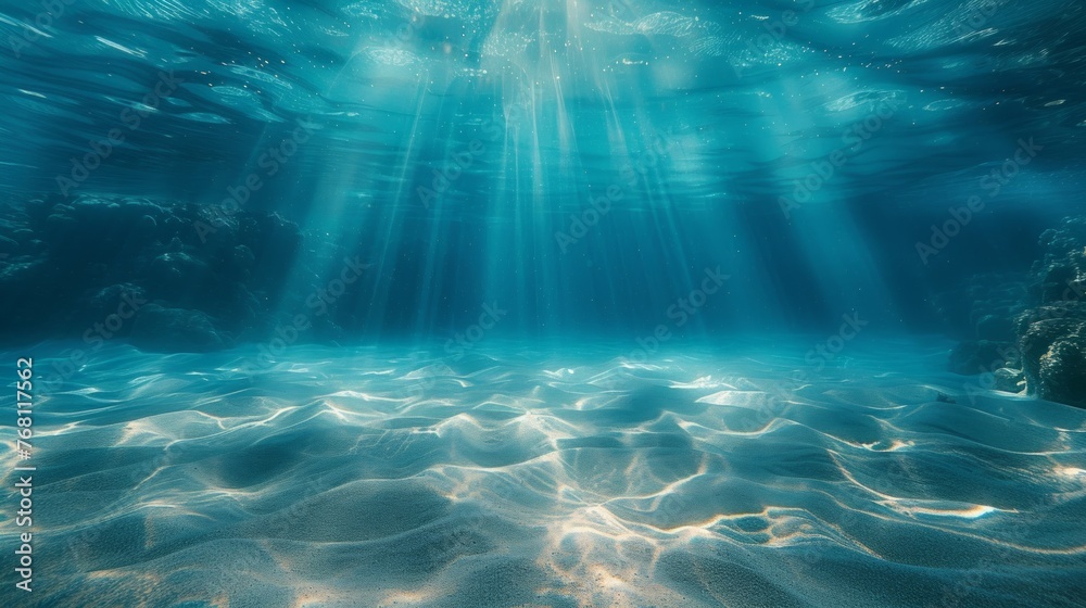 Underwater background featuring a deep blue sea with beautiful light rays piercing through the water Underwater background featuring a deep blue sea with beautiful light rays piercing through the water