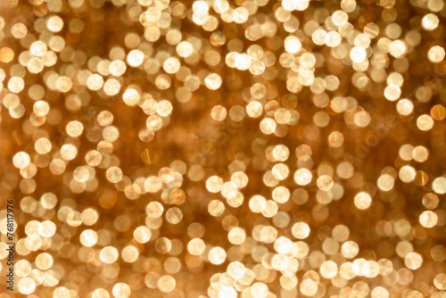 Shiny golden light patches, reflexes, reflextions and glow. Abstract defocused background photo