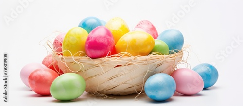 A woven basket overflowing with vibrant and assorted eggs  all in different shapes and colors  placed against a plain white background.