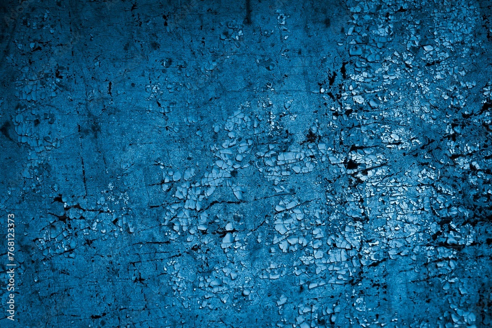 blue wall painted with white old peeling paint
