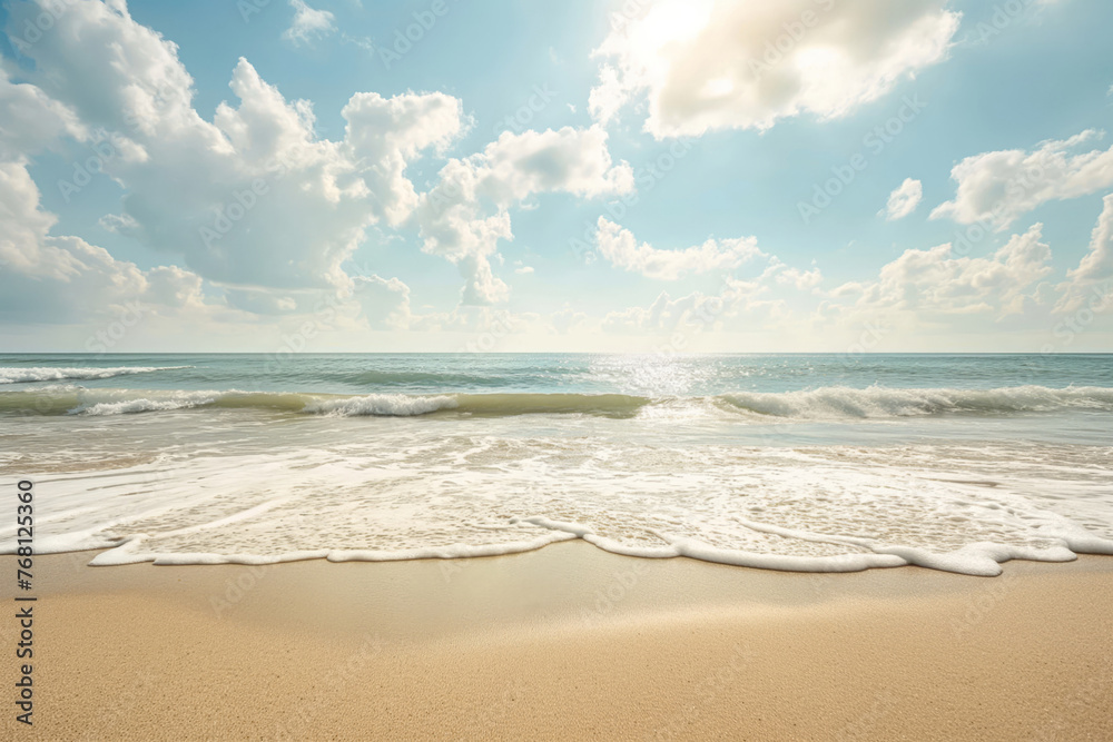 A tranquil beach scene with gentle waves washing ashore under a bright sky dotted with clouds. The sun's rays cast a warm glow, highlighting the natural beauty and serenity of the seaside.