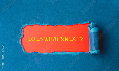Lettering 2025 what's next? Year 2025 in a torn piece of cardboard. Enter the new year.