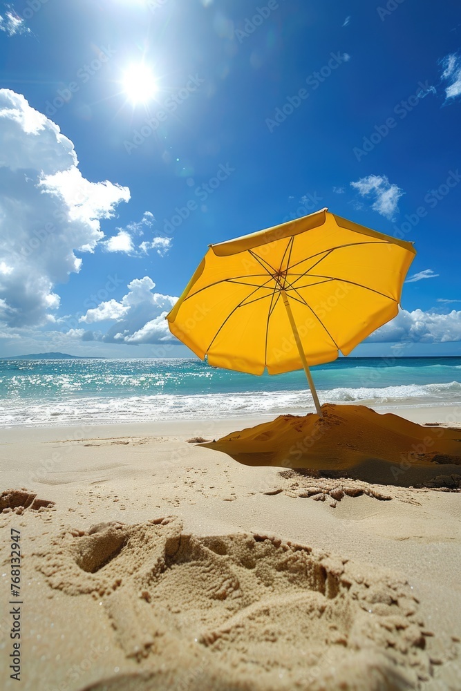 Yellow Beach Umbrella shading from the Summer Sun on the Beach