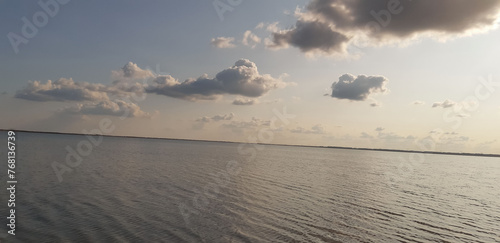 View of the rising sun over the lake in very calm morning light