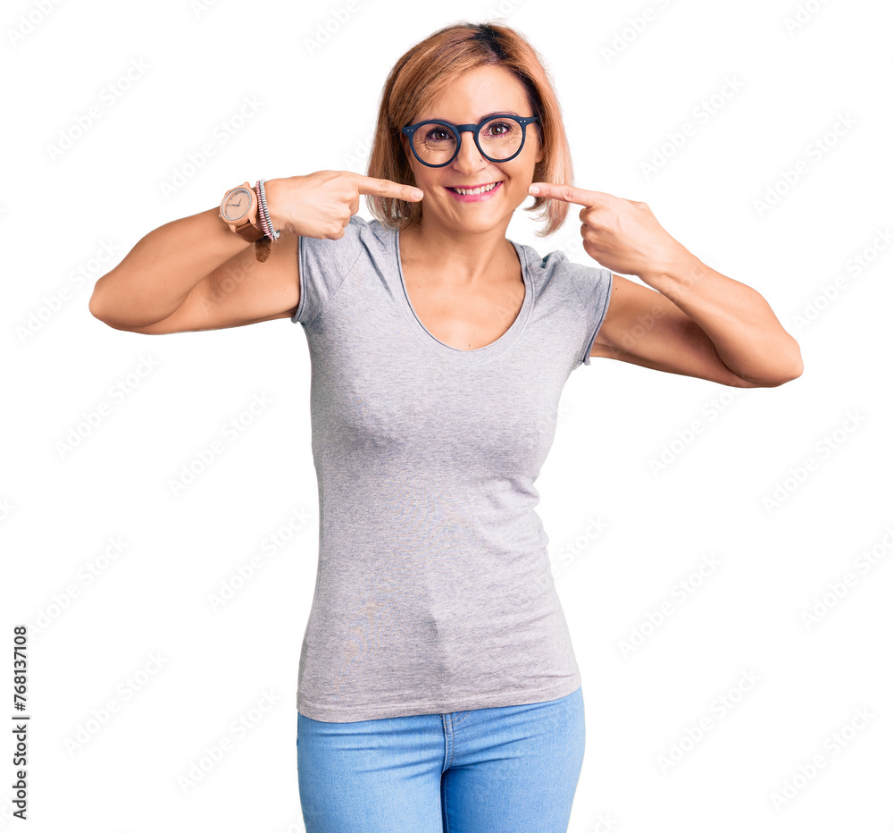 Young blonde woman wearing casual clothes smiling cheerful showing and pointing with fingers teeth and mouth. dental health concept. Young blonde woman wearing casual clothes smiling cheerful showing and pointing with fingers teeth and mouth. dental health concept.
