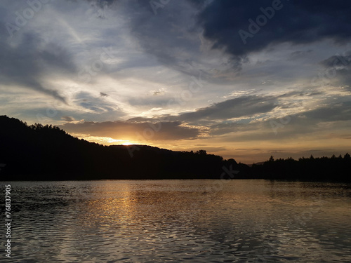 Sunset over the forest river. Beautiful sunset over river. River at sunset. Sunset river water