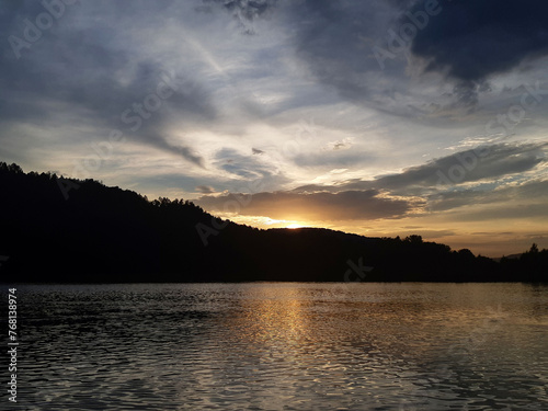 Sunset over the forest river. Beautiful sunset over river. River at sunset. Sunset river water