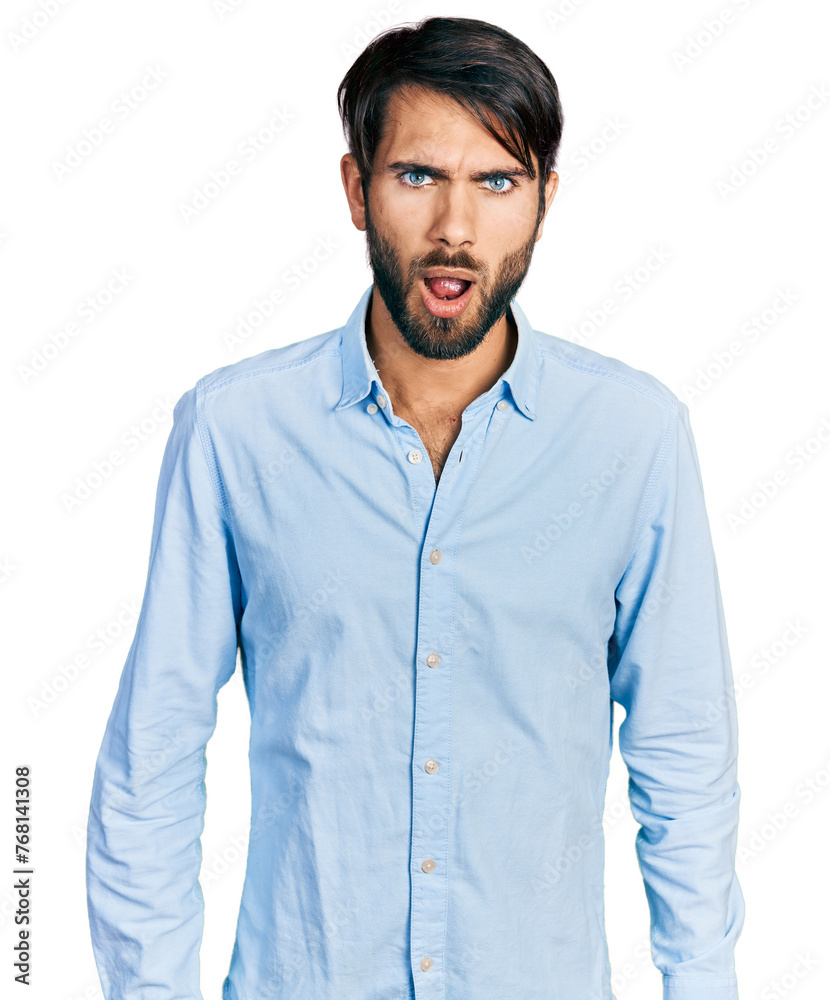 Hispanic man with blue eyes wearing business shirt afraid and shocked with surprise and amazed expression, fear and excited face.