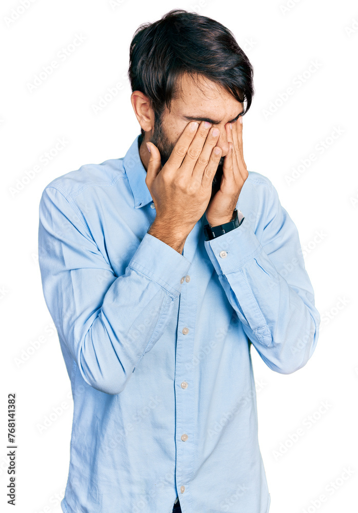 Hispanic man with blue eyes wearing business shirt rubbing eyes for fatigue and headache, sleepy and tired expression. vision problem Hispanic man with blue eyes wearing business shirt rubbing eyes for fatigue and headache, sleepy and tired expression. vision problem