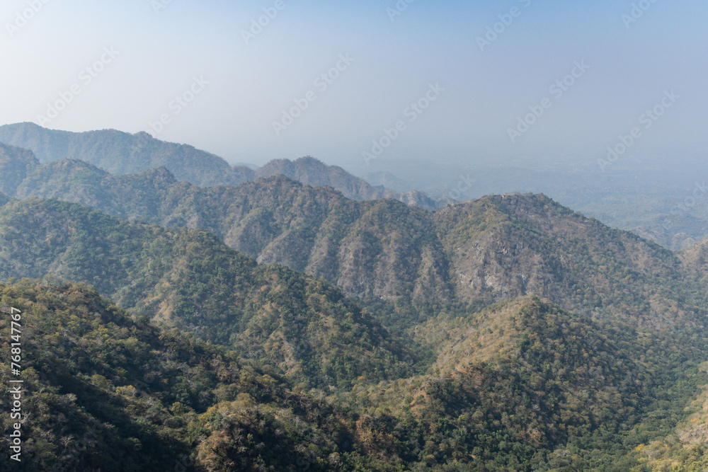 misty mountain range covered with fog at morning from flat angle