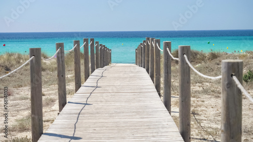 Wooden pontoon to the Son Bou beach in Menorca, Spain